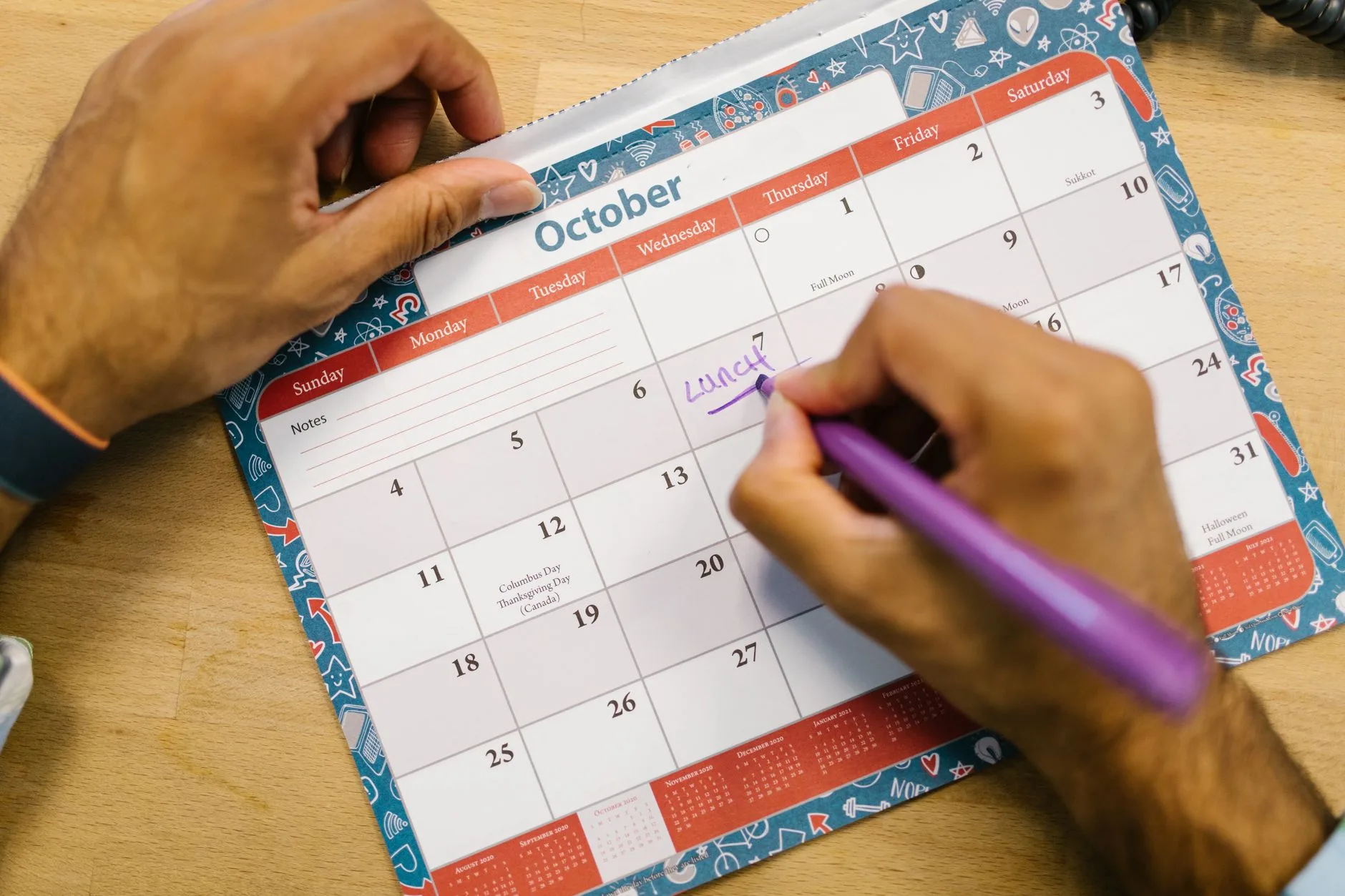 Understanding the Egg Donation Process Duration and Overview hands marking medical dates and appointments on a calendar planner